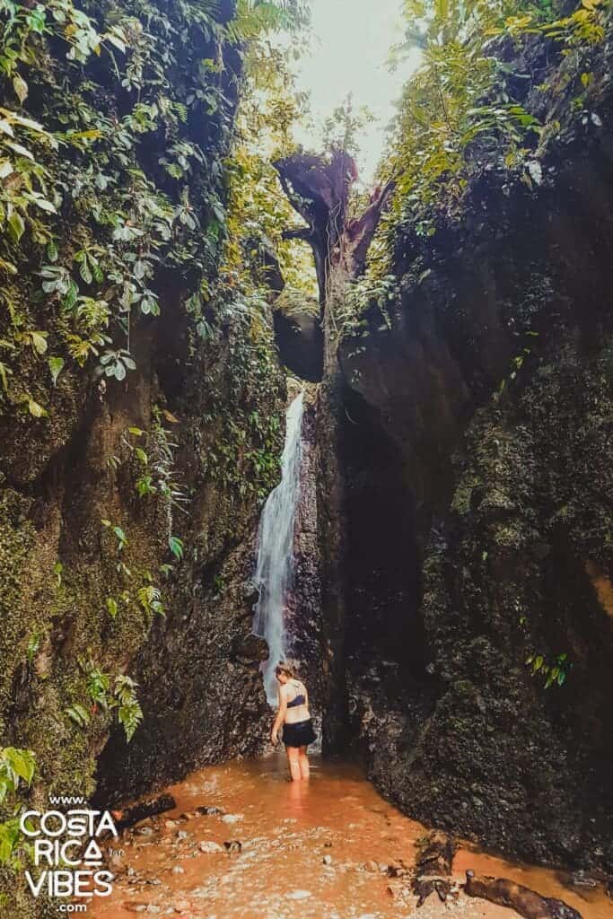 woman standing under waterfall in La Fortuna Costa Rica