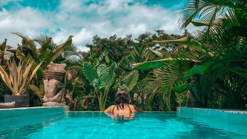 woman's back looking at jungle from pool in santa teresa costa rica