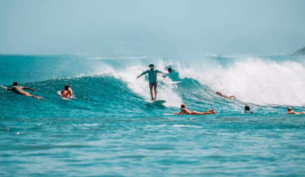 surfers catching a wave at playa avellanas
