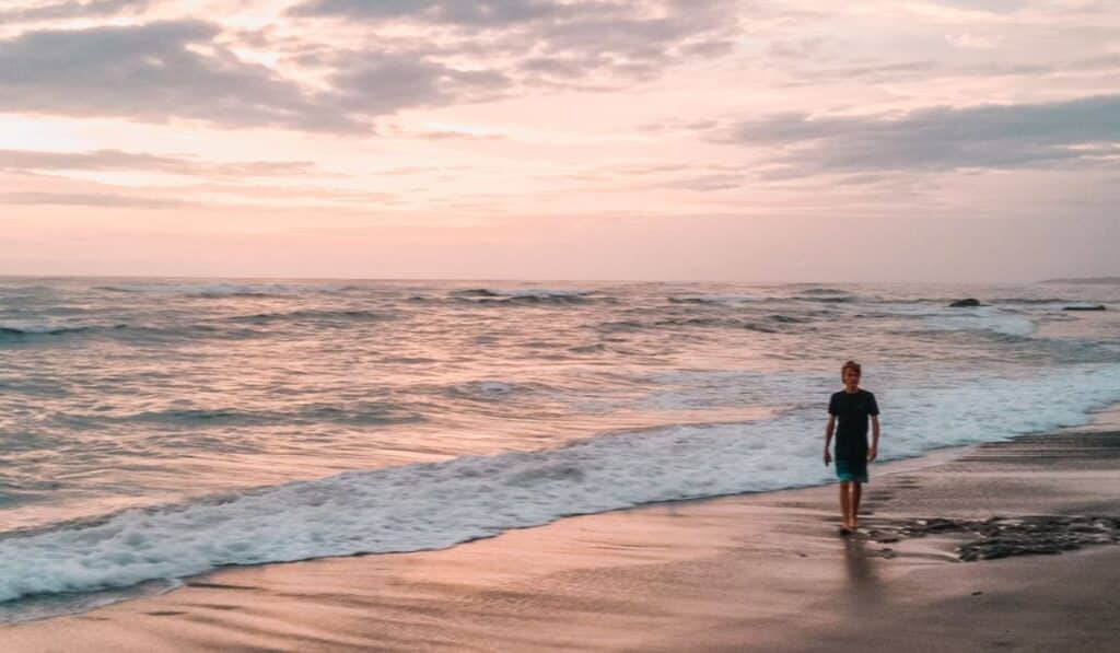 Thomas on beach in Nosara at sunset