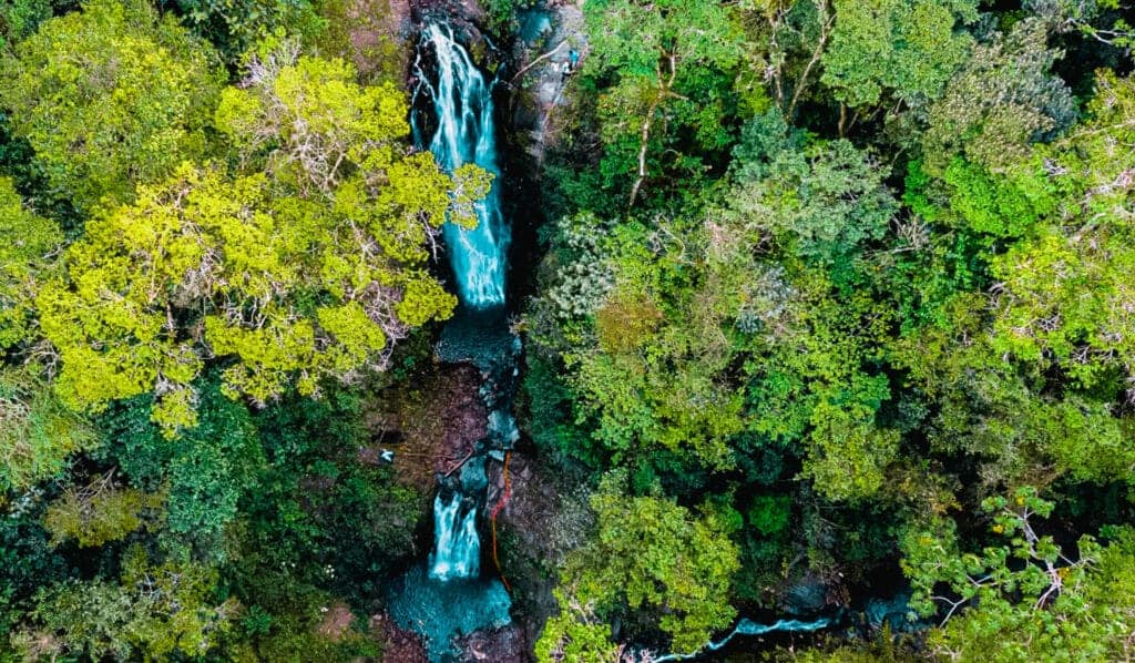 Man rapelling down series of waterfalls