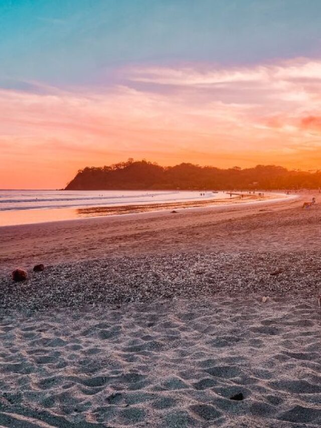 beach view with pink and orange sunset backdrop